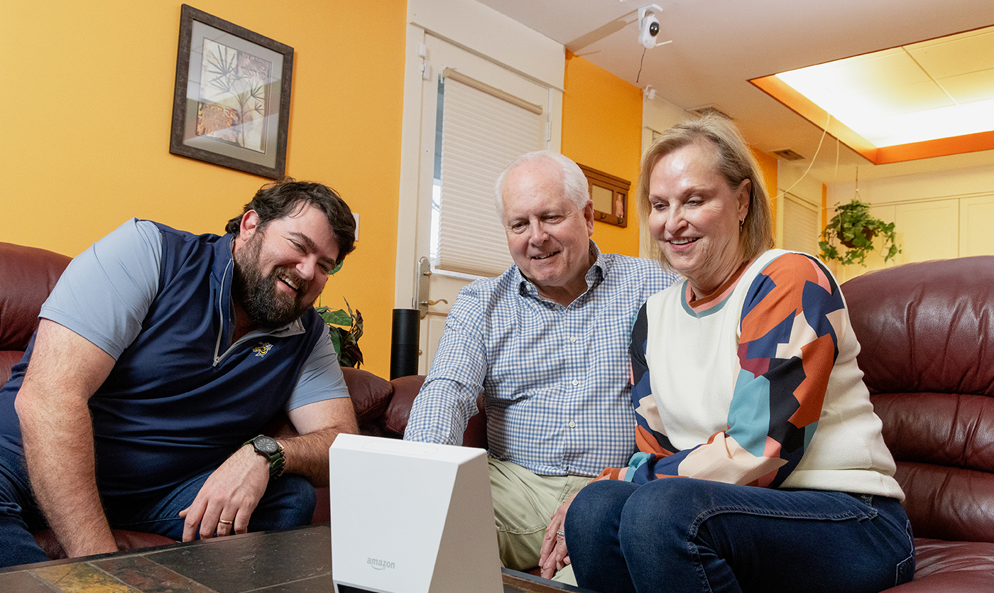 group of people sitting on couch using a virtual assistant