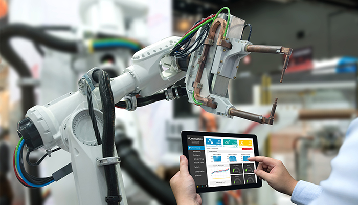 Engineer hand using tablet, heavy automation robot arm machine in smart factory industrial with tablet